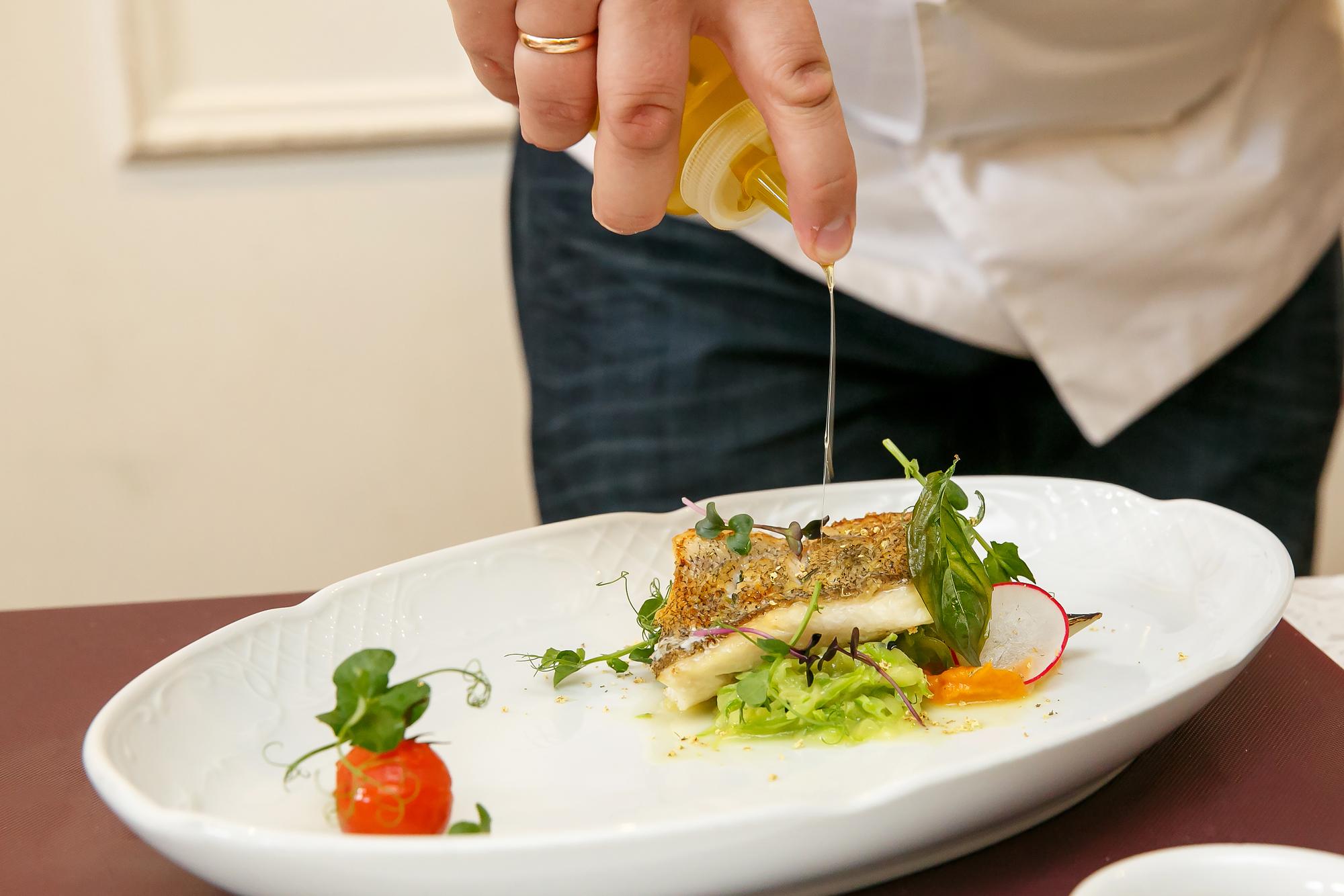 Close-up of seared fish with herb oil